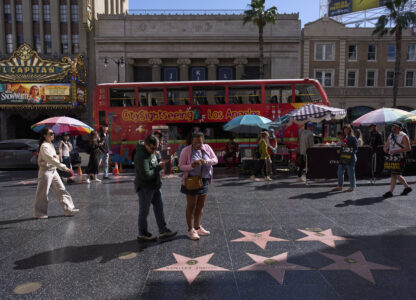 Tourists walk along the Hollywood Walk of Fame in Los Angeles, Friday, April 4, 2025. (AP Photo/Jae C. Hong)