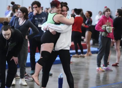 Raiden Hung, of Jurassic Gymnastics in Boston, center left, celebrates with teammate Fay Malay after competing in the floor exercise at the 2025 NAIGC national competition in Pittsburgh, Friday, April 4, 2025. (AP Photo/Gene J. Puskar)