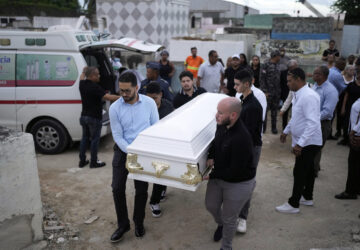 Relatives carry the coffin that contain the remains of Marilenny Pilarte who died at the Jet Set nightclub when its roof collapsed, during a burial service at a cemetery in Haina, Dominican Republic, Thursday, April 10, 2025. (AP Photo/Matias Delacroix)