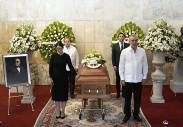 Dominican Republic President Luis Abinader, front right ands his wife Raquel Arbaje Soni, front left, attend the wake of Dominican singer Rubby Perez who died in the roof collapse at the Jet Set nightclub during his merengue concert, at the Eduardo Brito National Theater in Santo Domingo, Dominican Republic, Thursday, April 10, 2025. (AP Photo/Matias Delacroix)