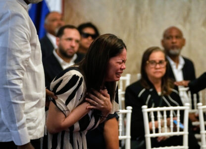 Zulinka, center, the daughter of Dominican singer Rubby Perez who died in the roof collapse at the Jet Set nightclub during his merengue concert, cries during his wake at the Eduardo Brito National Theater in Santo Domingo, Dominican Republic, Thursday, April 10, 2025. (AP Photo/Matias Delacroix)