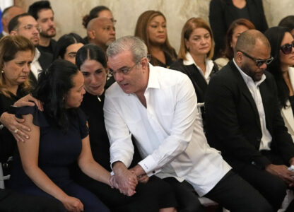 Dominican Republic President Luis Abinader, center right, and his wife Raquel Arbaje Soni speak with the family of Dominican singer Rubby Perez who died in the roof collapse at the Jet Set nightclub while performing in concert, during the wake at the Eduardo Brito National Theater in Santo Domingo, Dominican Republic, Thursday, April 10, 2025. (AP Photo/Matias Delacroix)