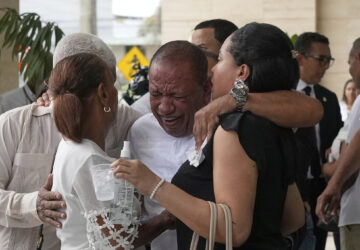 Family members mourn during the memorial of Octavio Dotel, a former MLB baseball player who died at the Jet Set nightclub where more than 200 people were killed when its roof collapsed, in Santo Domingo, Dominican Republic, Thursday, April 10, 2025. (AP Photo/Matias Delacroix)