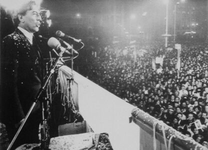 FILE - Writer Mario Vargas Llosa speaks at a rally in Lima, Peru, Aug. 21, 1987, to a crowd of more than 50,000 people. (AP Photo/A. Balaguer, File)
