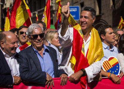 FILE - Nobel laureate Mario Vargas Llosa, second from left, stands next to Popular Party leader in Catalonia Xavier Garcia Albiol, right, as they lead a march to protest the Catalan government's push for secession from the rest of Spain in downtown Barcelona, Spain, Oct. 8, 2017. (AP Photo/Emilio Morenatti, File)