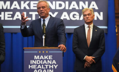 U.S. Health and Human Services Secretary Robert F. Kennedy, Jr speaks as Centers for Medicare and Medicaid Services Administrator Dr. Mehmet Oz listens during a Make Indiana Healthy Again initiative event in Indianapolis, Tuesday, April 15, 2025. (AP Photo/Michael Conroy)