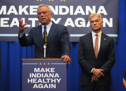 U.S. Health and Human Services Secretary Robert F. Kennedy, Jr speaks as Centers for Medicare and Medicaid Services Administrator Dr. Mehmet Oz listens during a Make Indiana Healthy Again initiative event in Indianapolis, Tuesday, April 15, 2025. (AP Photo/Michael Conroy)