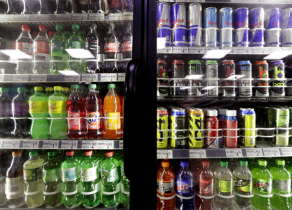 FILE - Soft drinks fill a drink cooler in a convenience store in Kent, Wash., Oct. 1, 2018. (AP Photo/Elaine Thompson, File)