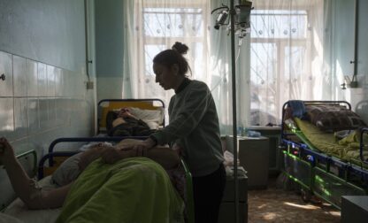 Hanna seeks to her husband Victor Voitenko, injured in a deadly Palm Sunday Russian attack on Sumy on April 13, at a hospital in Sumy, Ukraine, Tuesday, April 15, 2025. (AP Photo/Evgeniy Maloletka)