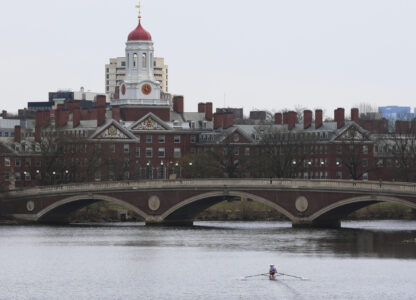 A sculler rows down the Charles River near Harvard University, at rear, Tuesday, April 15, 2025, in Cambridge, Mass. (AP Photo/Charles Krupa)