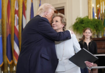 President Donald Trump, left, hugs Secretary of Education Linda McMahon after he signed an executive order in the East Room of the White House in Washington, Thursday, March 20, 2025. (AP Photo/Ben Curtis)