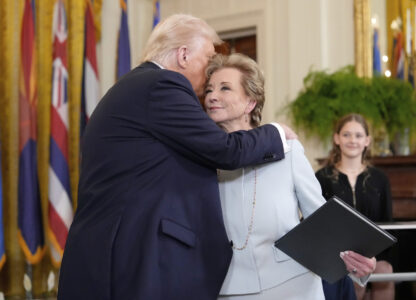 President Donald Trump, left, hugs Secretary of Education Linda McMahon after he signed an executive order in the East Room of the White House in Washington, Thursday, March 20, 2025. (AP Photo/Ben Curtis)