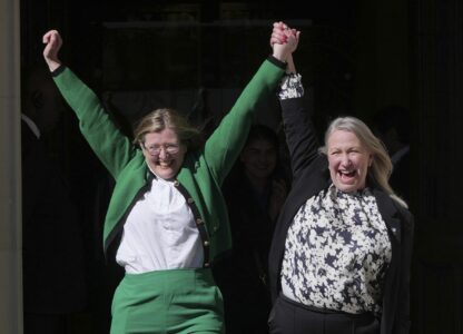 Marion Calder, right, and Susan Smith, left, from For Women Scotland, celebrate outside after the U.K. Supreme Court ruled that a woman is someone born biologically female, excluding transgender people from the legal definition in a long-running dispute between the feminist group and the Scottish government, in London Wednesday, April 16, 2025. (AP Photo/Kin Cheung)