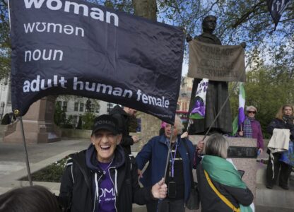 Women's rights activists hold placards outside the Supreme Court to challenge gender recognition laws, in London, Wednesday, April 16, 2025. (AP Photo/Kin Cheung)