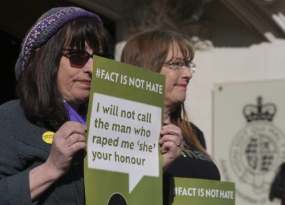 Women's rights activists hold placards outside the Supreme Court to challenge gender recognition laws, in London, Wednesday, April 16, 2025. (AP Photo/Kin Cheung)