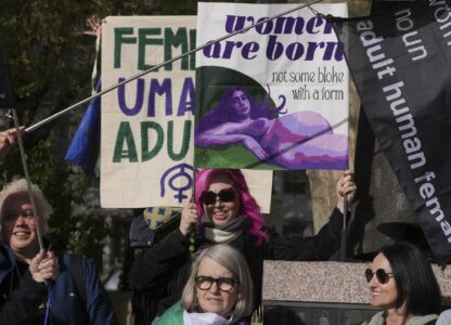 Women's rights activists hold placards outside the Supreme Court to challenge gender recognition laws, in London, Wednesday, April 16, 2025. (AP Photo/Kin Cheung)