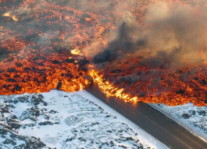 Lava crosses the main road to Grindavík and flows on the road leading to the Blue Lagoon in Grindavík, Iceland, Feb. 8, 2024. (AP Photo/Marco Di Marco)