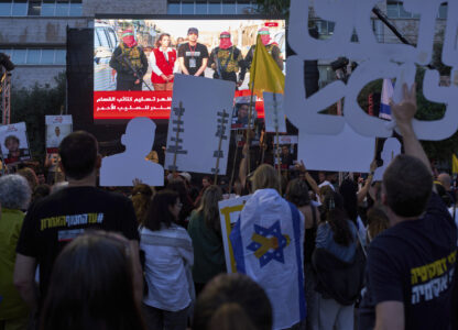 People watch a live broadcast of Israeli-American soldier Edan Alexander as he is released from Hamas captivity in Gaza, at a plaza known as the hostages square in Tel Aviv, Monday, May 12, 2025. Alexander was abducted during the Hamas-led attack on his base on October 7, 2023. (AP Photo/Oded Balilty)