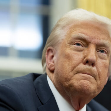 FILE - President Donald Trump speaks with reporters as he signs executive orders in the Oval Office at the White House, Feb. 10, 2025, in Washington. (AP Photo/Alex Brandon, file)