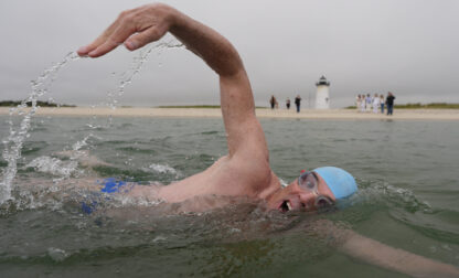 Endurance swimmer Lewis Pugh swims near the Edgartown Harbor Light, Thursday, May 15, 2025, in Edgartown, Mass. (AP Photo/Robert F. Bukaty)