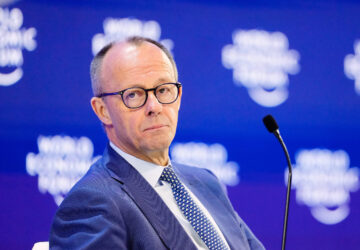 German Chancellor Friedrich Merz sits on the podium during the Annual Meeting of the World Economic Forum in Davos, Switzerland, Thursday, Jan. 22, 2026. (AP Photo/Markus Schreiber)