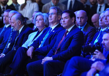 United States Secretary of State Marco Rubio, center, right, sits with U.S. Treasury Secretary Scott Bessent, center, and White House chief of staff Susie Wiles, center left, as they listen to the address of President Donald Trump during the Annual Meeting of the World Economic Forum in Davos, Switzerland, Wednesday, Jan. 21, 2026. (AP Photo/Evan Vucci)