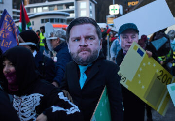 People wearing masks depicting United States Vice President JD Vance, center, and Elon Musk, right, attend a demonstration against the United President Donald Trump and the Annual Meeting of the World Economy Forum in Davos, Switzerland, Sunday, Jan. 18, 2026. (AP Photo/Markus Schreiber)