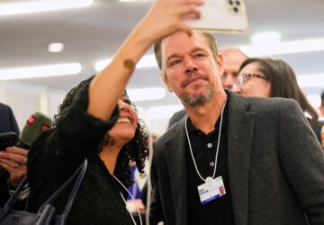 A woman makes a selfie with her phone with American actor Matt Damon during the Annual Meeting of the World Economic Forum in Davos, Switzerland, Tuesday, Jan. 20, 2026. (AP Photo/Markus Schreiber)