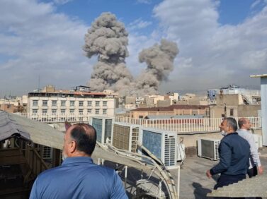 FILE - People watch as smoke rises on the skyline after an explosion in Tehran, Iran, Feb. 28, 2026. (AP Photo, File)