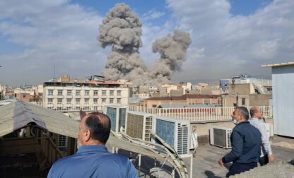 FILE - People watch as smoke rises on the skyline after an explosion in Tehran, Iran, Feb. 28, 2026. (AP Photo, File)