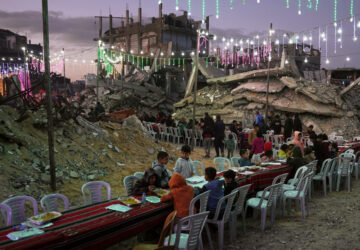 FILE - Palestinians gather amid the rubble of destroyed buildings as they gather for their fast-breaking meal during the Muslim holy month of Ramadan, in Khan Younis, Gaza Strip, Feb. 19, 2026. (AP Photo/Abdel Kareem Hana, File)