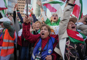 FILE - Iranians show their support for the U.S. and Israeli strikes on Iran, in Berlin, Germany, Feb. 28, 2026. (AP Photo/Markus Schreiber, File)