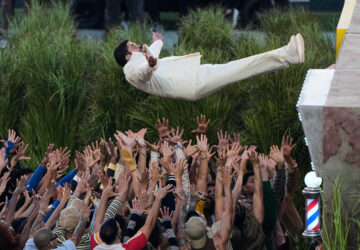 FILE - A crew reaches up to catch Bad Bunny during his NFL Super Bowl LX halftime performance, in Santa Clara, Calif., Feb. 8. 2026. (AP Photo/Charlie Riedel, File)