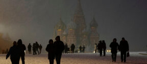 Snow falls on people walking through Red Square in front of St. Basil's Cathedral in Moscow as temperatures hover just below freezing, April 8, 2025. (AP Photo / Alexander Zemlianichenko)