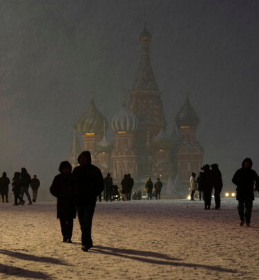 Snow falls on people walking through Red Square in front of St. Basil's Cathedral in Moscow as temperatures hover just below freezing, April 8, 2025. (AP Photo / Alexander Zemlianichenko)