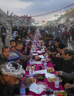 Palestinians sit at a large table surrounded by the rubble of destroyed homes and buildings as they gather for iftar, the fast-breaking meal, on the first day of Ramadan in Rafah, southern Gaza Strip, March 1, 2025. (AP Photo / Abdel Kareem Hana)