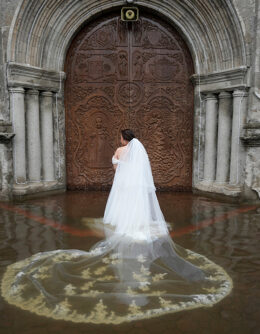 Bride Jamaica Aguilar prepares to enter the flooded Barasoain church for her wedding in Malolos, Bulacan province, Philippines, July 22, 2025. (AP Photo / Aaron Favila)