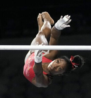 Simone Biles, a seven-time Olympic medalist and the 2016 Olympic champion, practices on the uneven bars at the U.S. Classic gymnastics competition Friday, Aug. 4, 2023, in Hoffman Estates, Ill. (AP Photo/Morry Gash)